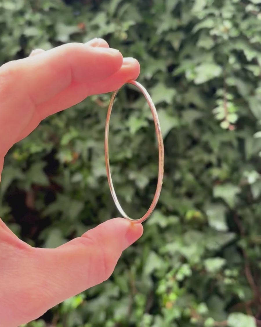 solid round bangle being held