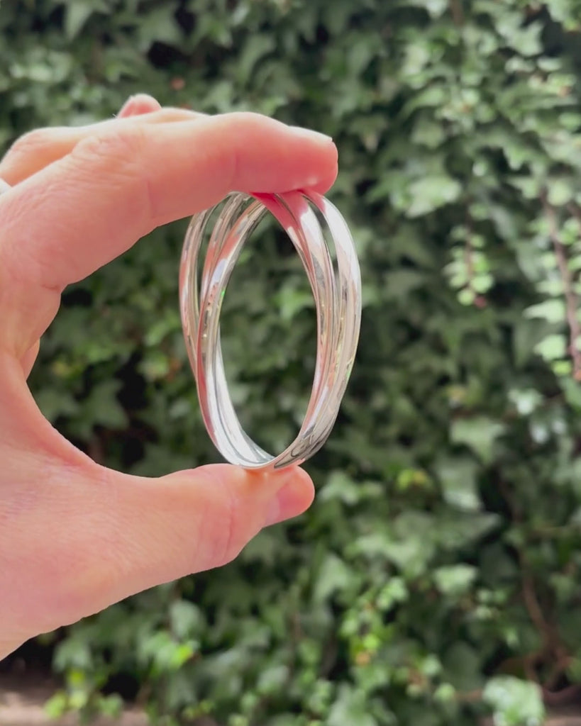 solid silver triple bangle being rotated