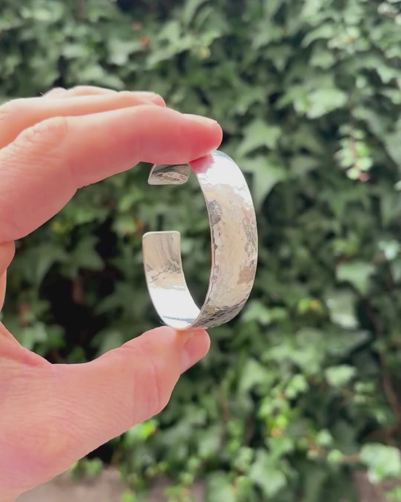 silver bangle being held