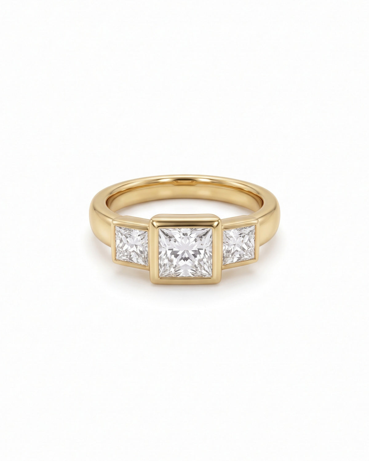 Gold trilogy engagement ring featuring three princess cut diamonds in a bezel setting.