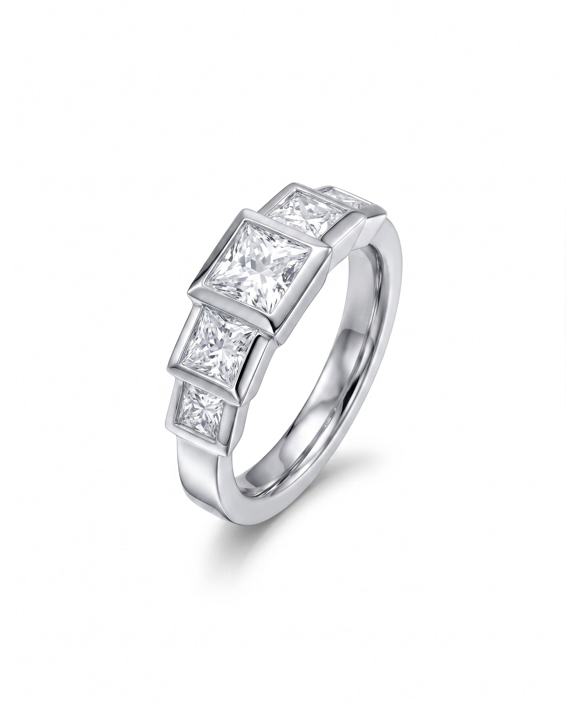 Silver ring with three princess cut diamonds in a bezel setting.
