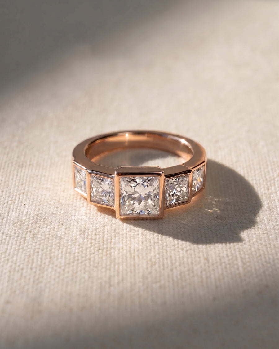 Rose gold ring with five princess-cut lab grown diamonds.