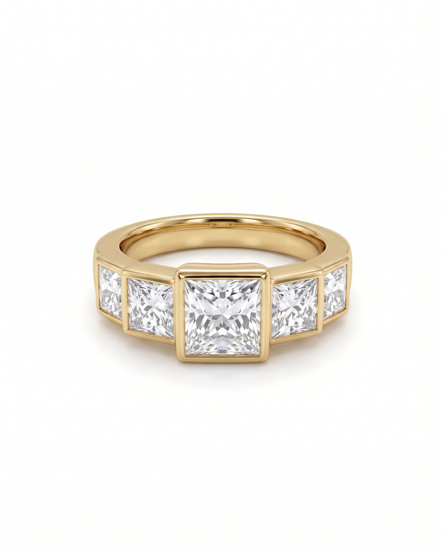 Five princess cut diamonds set in a yellow gold band with a bezel setting.
