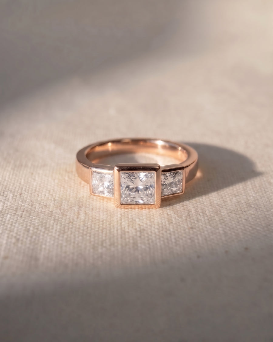 18ct rose gold engagement ring with three princess cut lab grown diamonds.