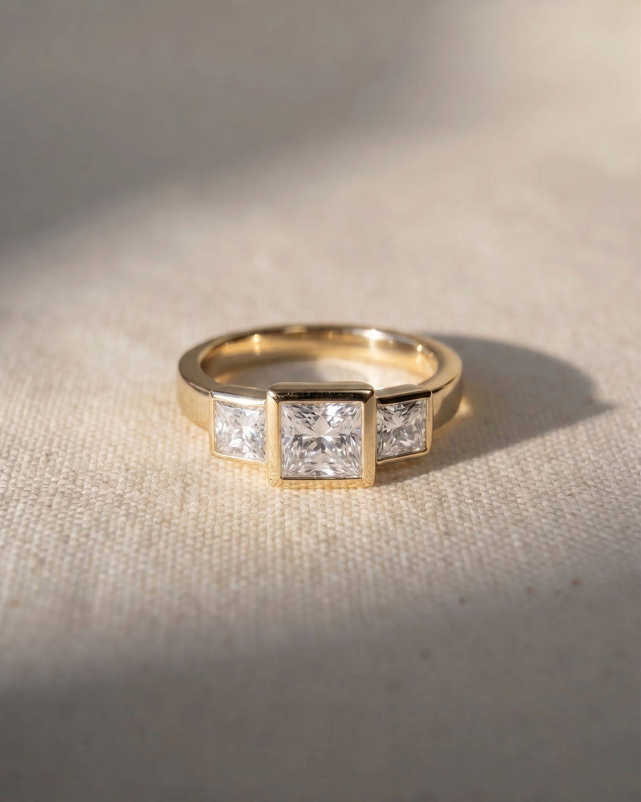 18ct yellow gold trilogy ring with three princess cut lab grown diamonds.