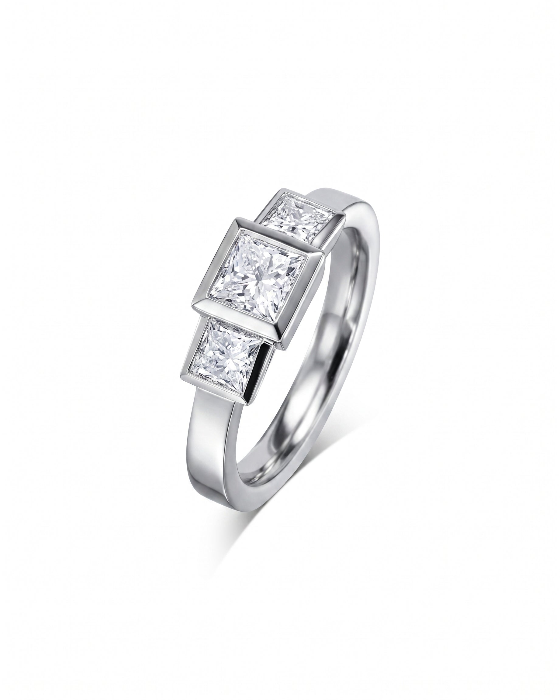 White gold ring with three princess cut diamonds.