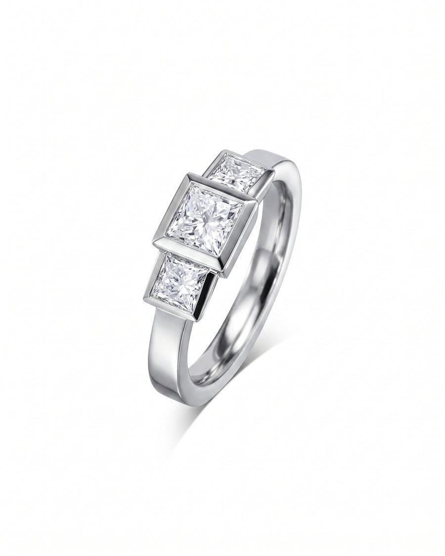 White gold ring with three princess cut diamonds.
