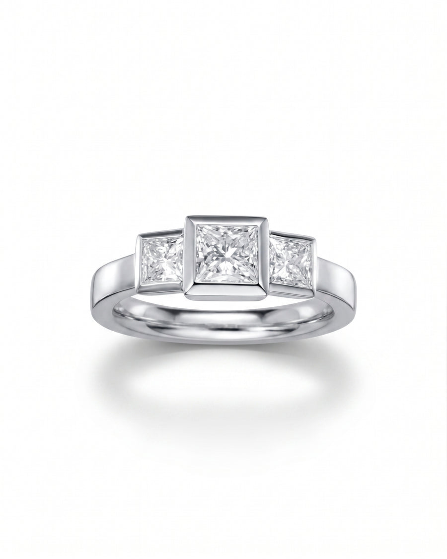 Silver ring with three princess cut diamonds.
