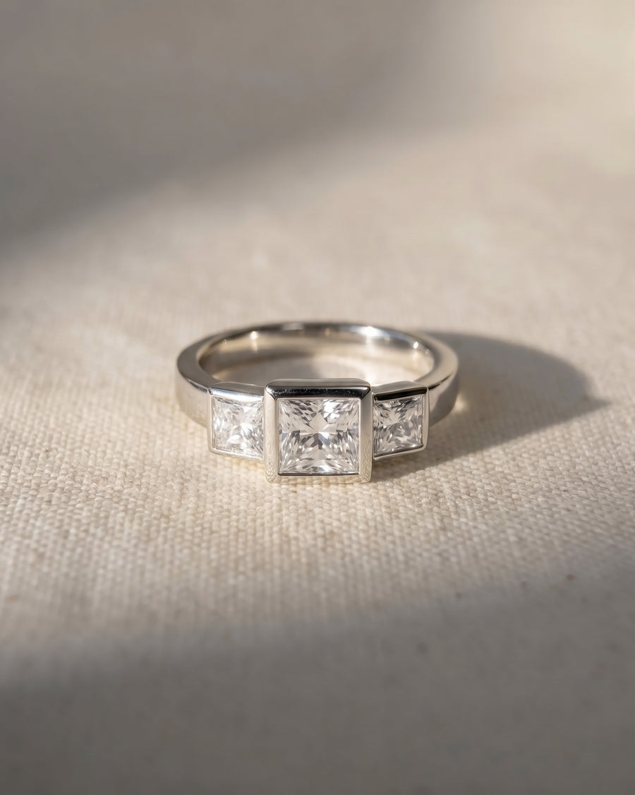 Platinum princess cut lab grown diamond trilogy engagement ring.