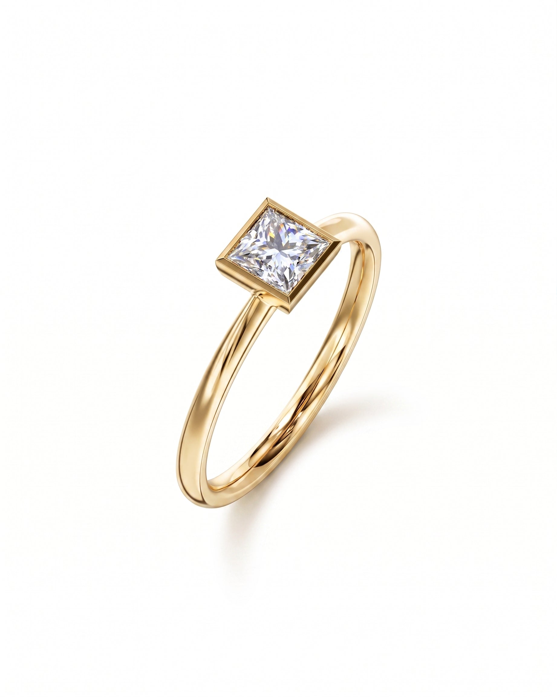 Princess cut diamond engagement ring in a gold bezel setting on a plain polished gold band.