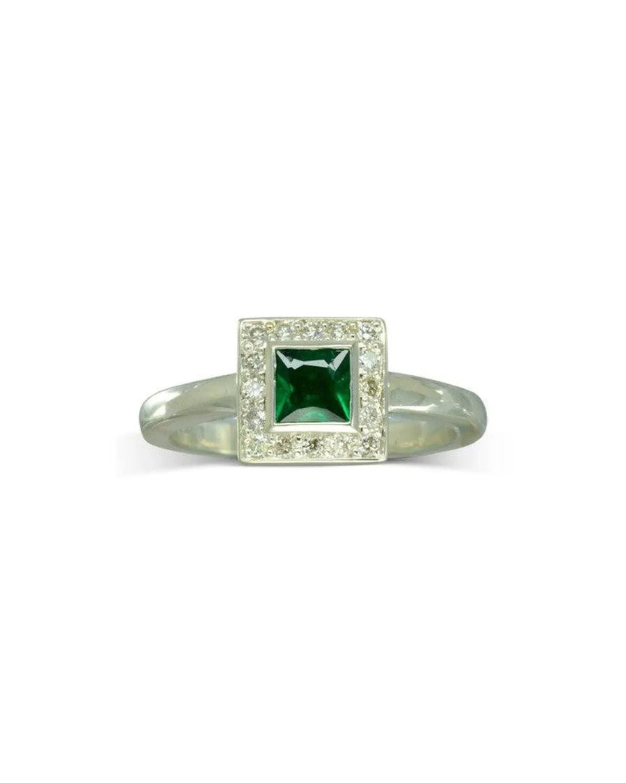 Silver ring with a princess cut emerald and diamond cluster.