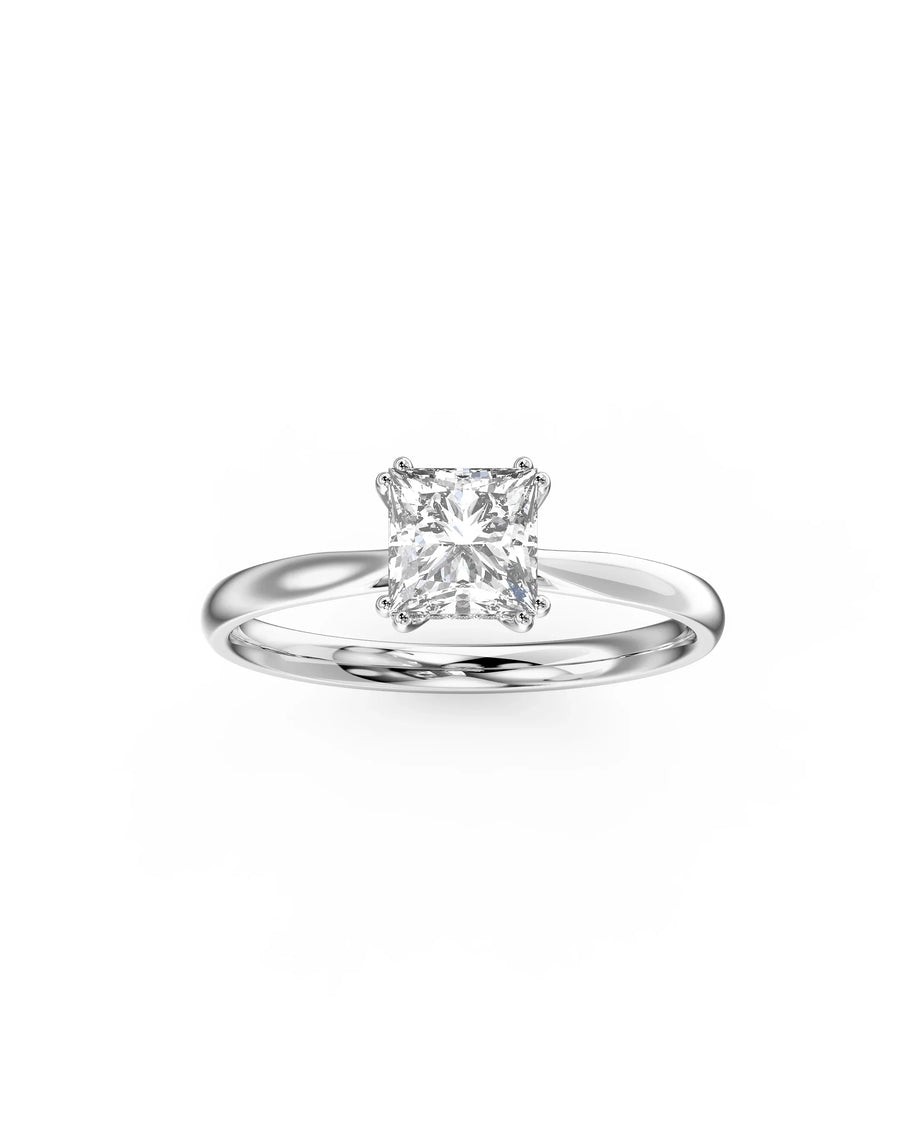 Handmade white gold solitaire ring with a princess cut diamond on a plain band