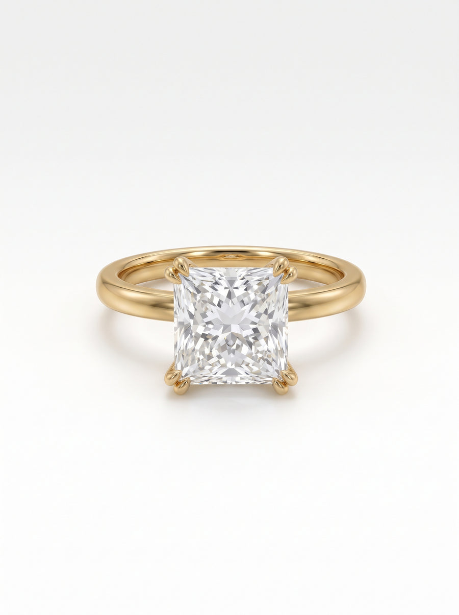 Princess cut diamond engagement ring with a hidden halo set in a polished yellow gold band.