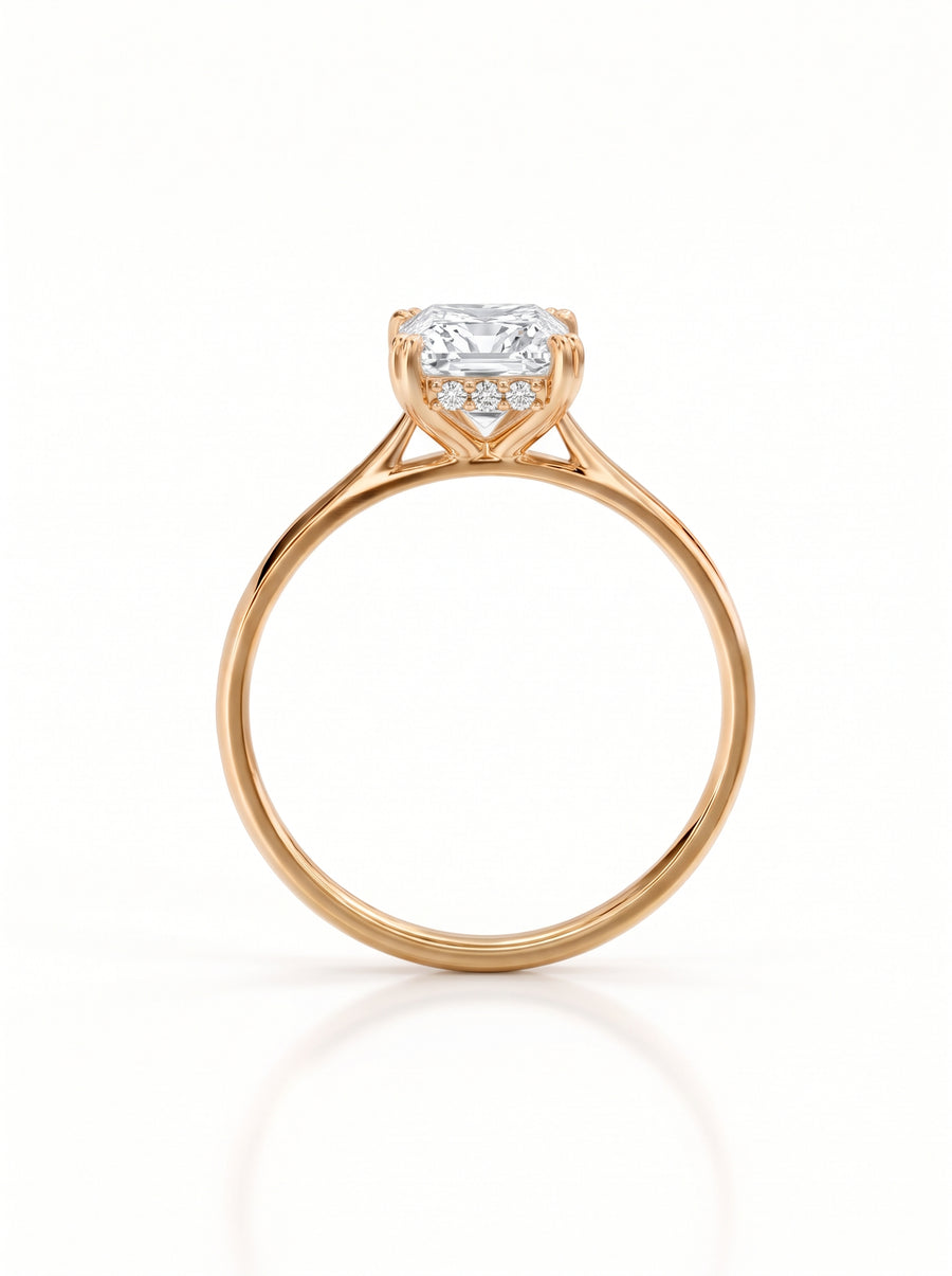 Princess cut diamond engagement ring with a hidden halo on a rose gold band.