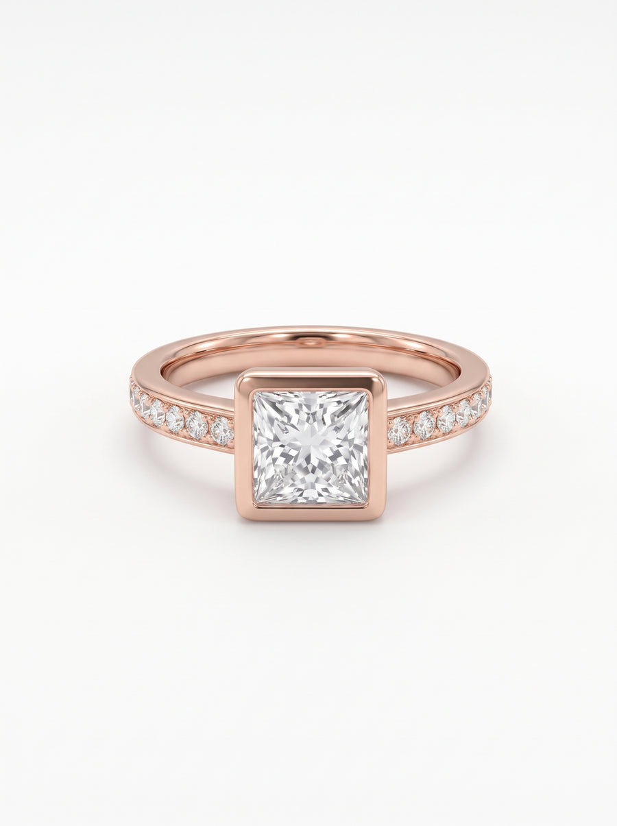 Rose gold engagement ring with a princess cut center diamond in a bezel setting and pavé diamond band.