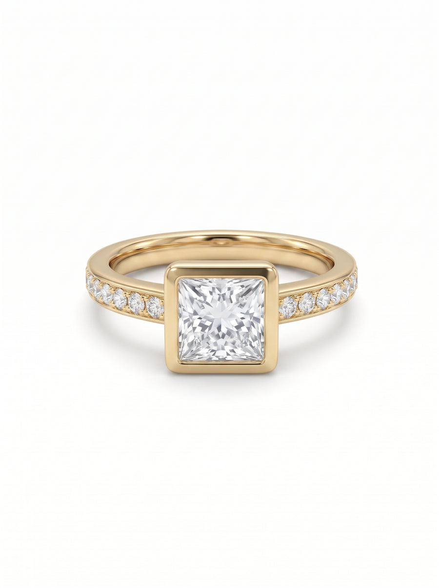 Princess cut diamond engagement ring in a gold bezel setting with a pavé diamond band.