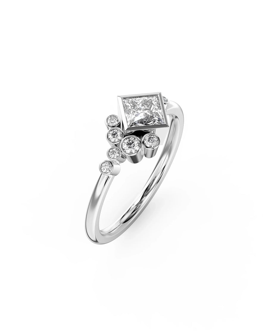 Silver princess cut diamond engagement ring with round side stones.