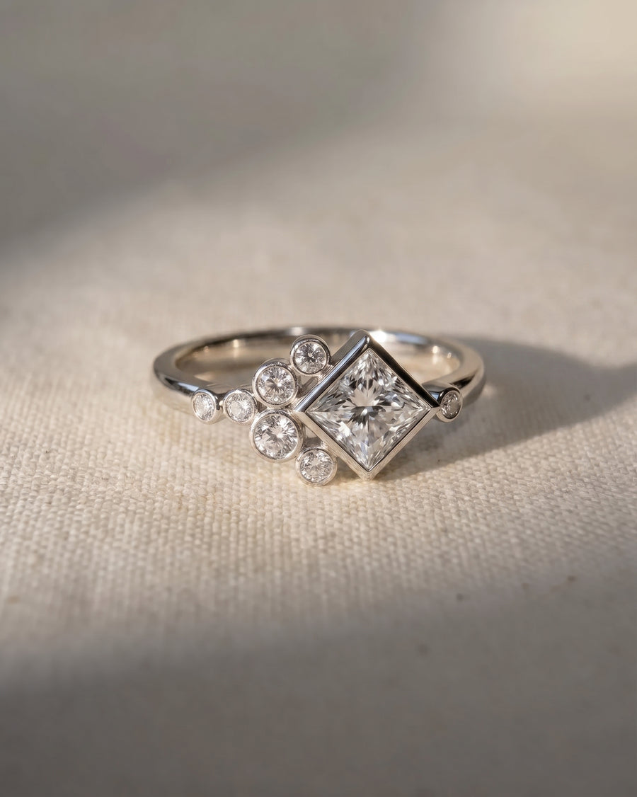 Platinum princess cut lab grown diamond ring with bubble accents.