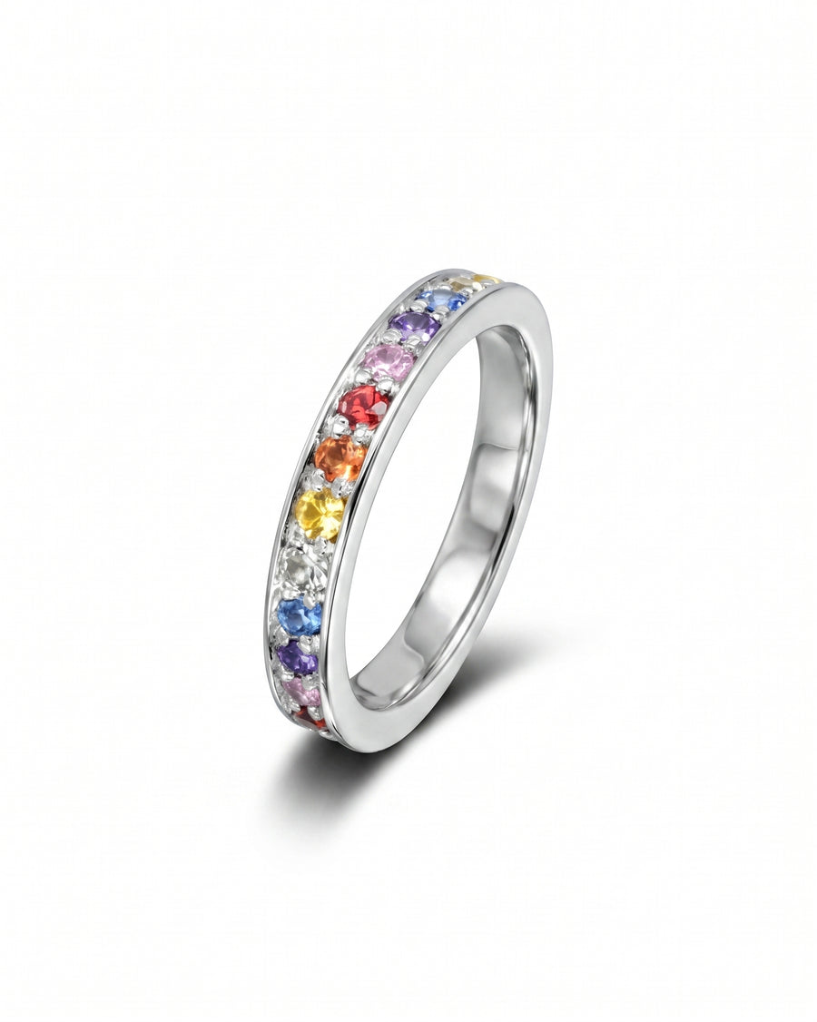 Silver eternity ring with rainbow sapphire gemstones.