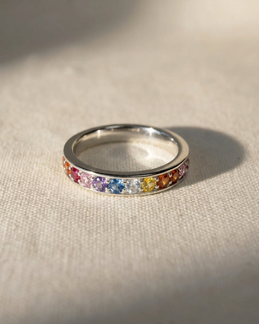 Silver eternity ring with rainbow sapphires.