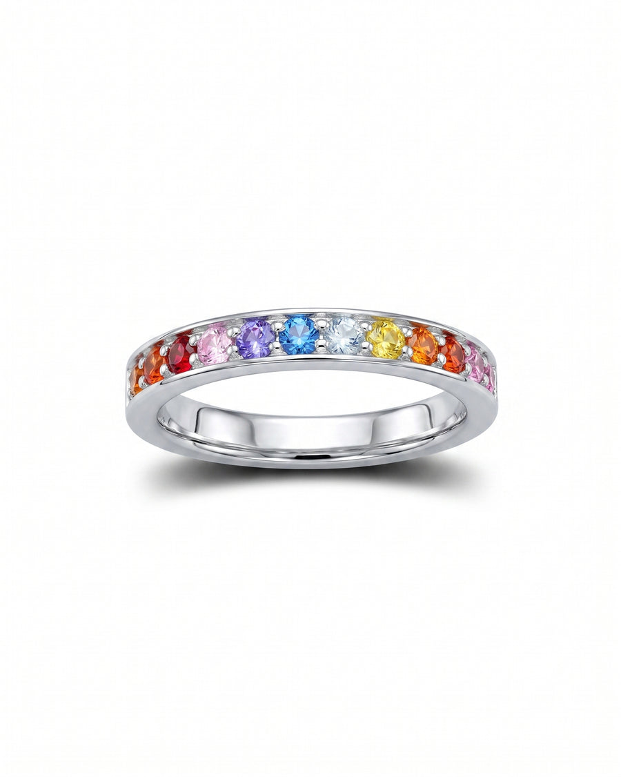 Silver eternity ring with rainbow sapphire gemstones.
