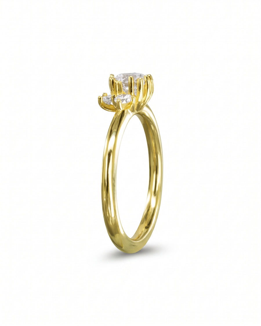 Gold engagement ring with a random claw cluster diamond.