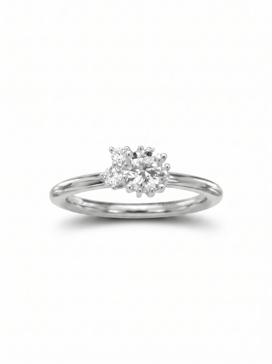 Silver engagement ring featuring a cluster of round diamonds set in a prong design on a polished band.
