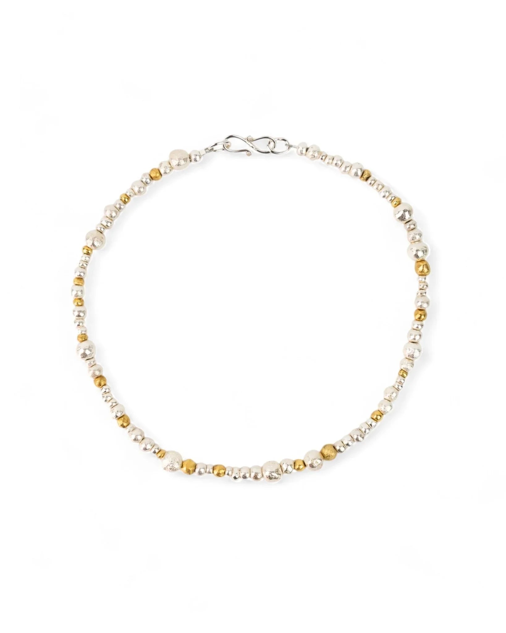 Handmade necklace with mixed silver and gold organic nugget beads on a white background