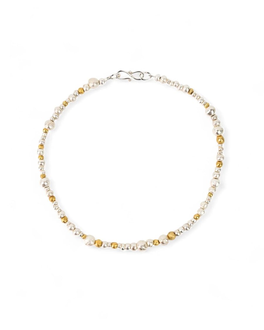 Handmade necklace with mixed silver and gold organic nugget beads on a white background