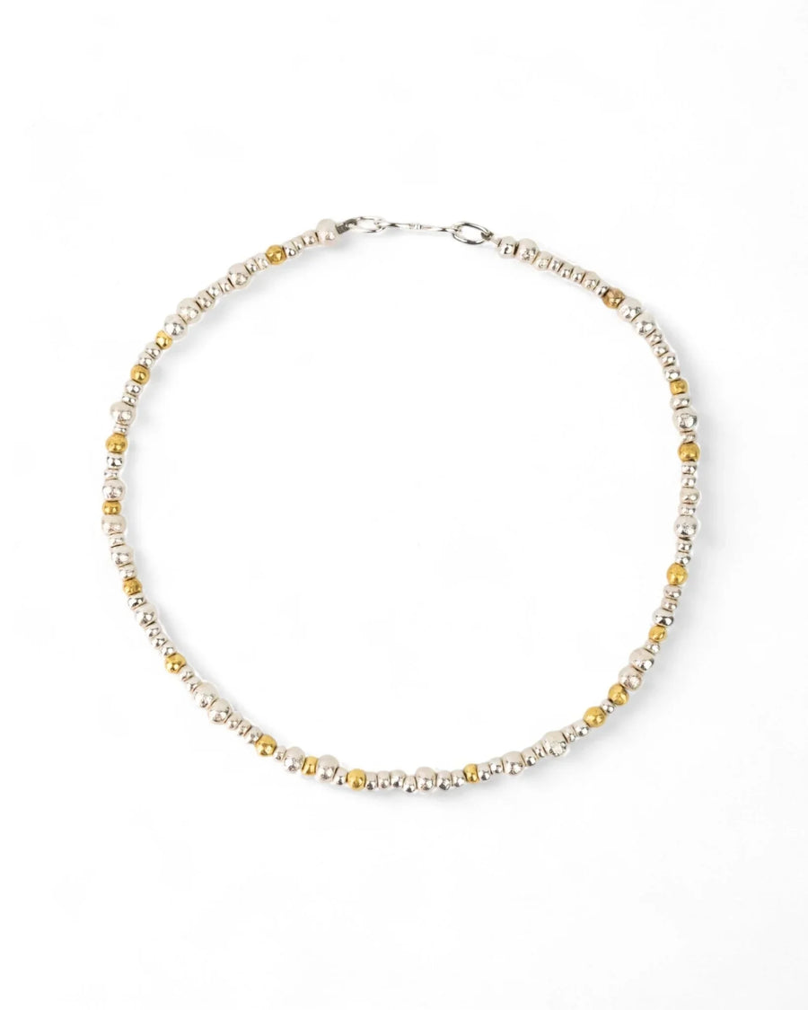 Handmade necklace with silver and gold nugget beads on a white background