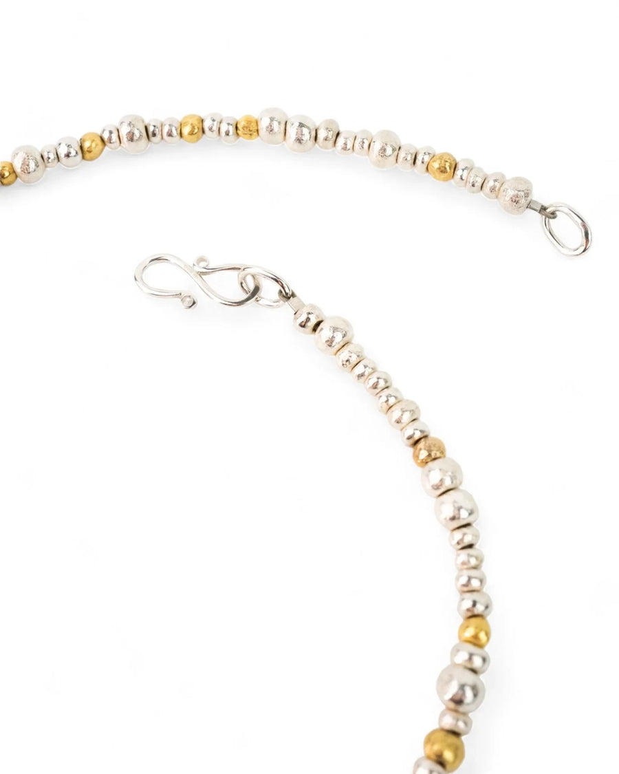 Handmade necklace with organic silver and gold nugget beads on a white background