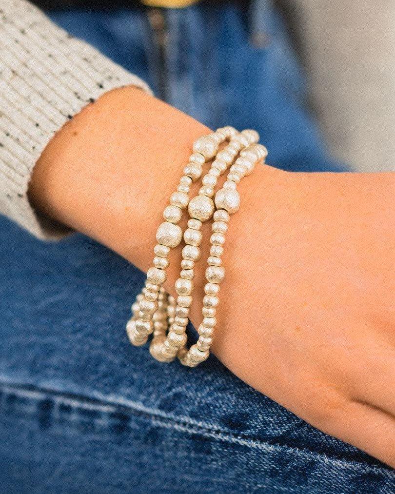 Triple strand silver nugget bracelet with organic shapes on wrist