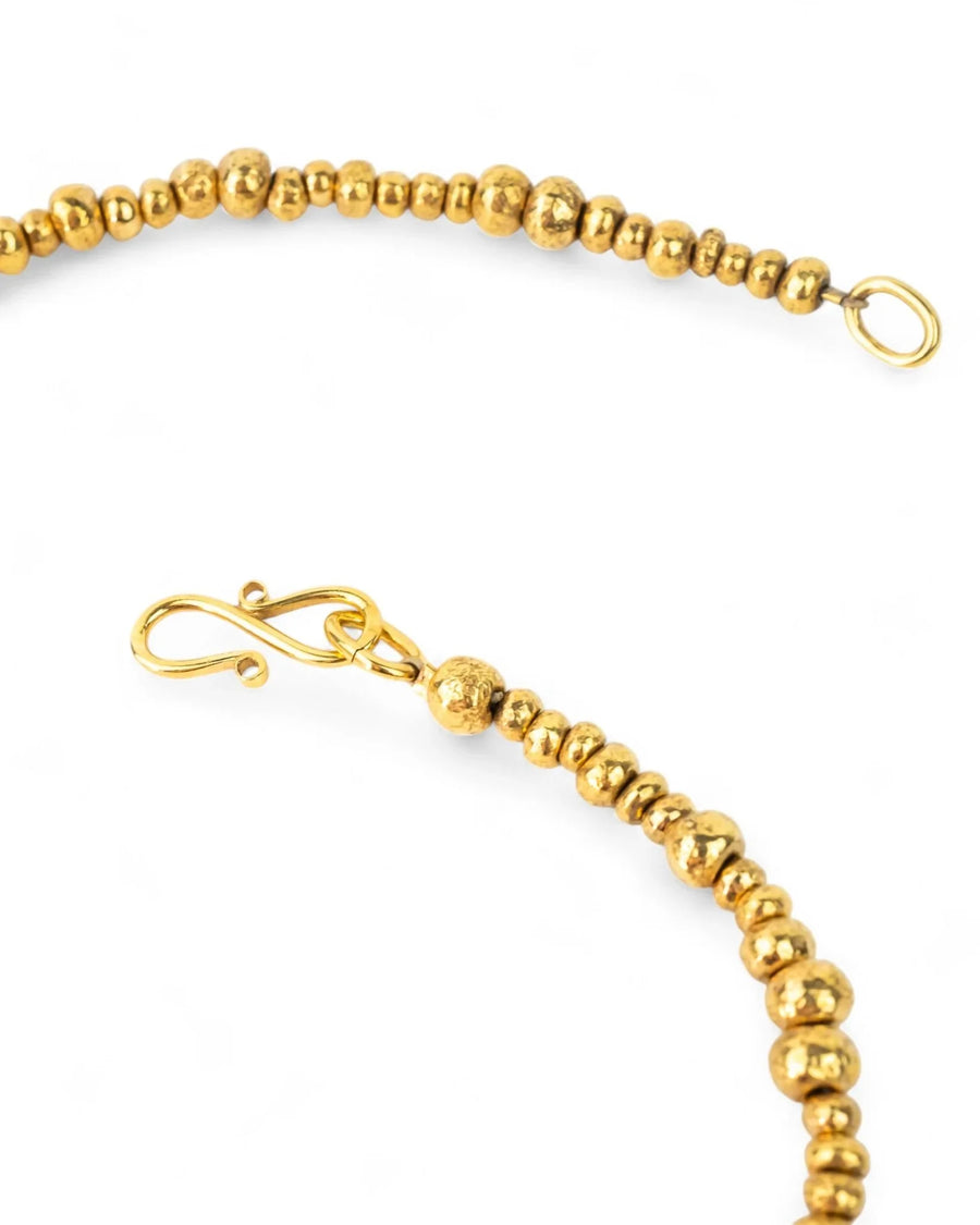 Yellow gold nugget bead necklace with organic textured finish and hook clasp on white background