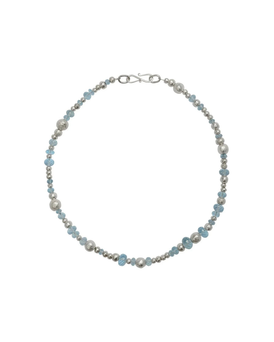 Handmade necklace with silver nugget beads and blue topaz gemstones on white background