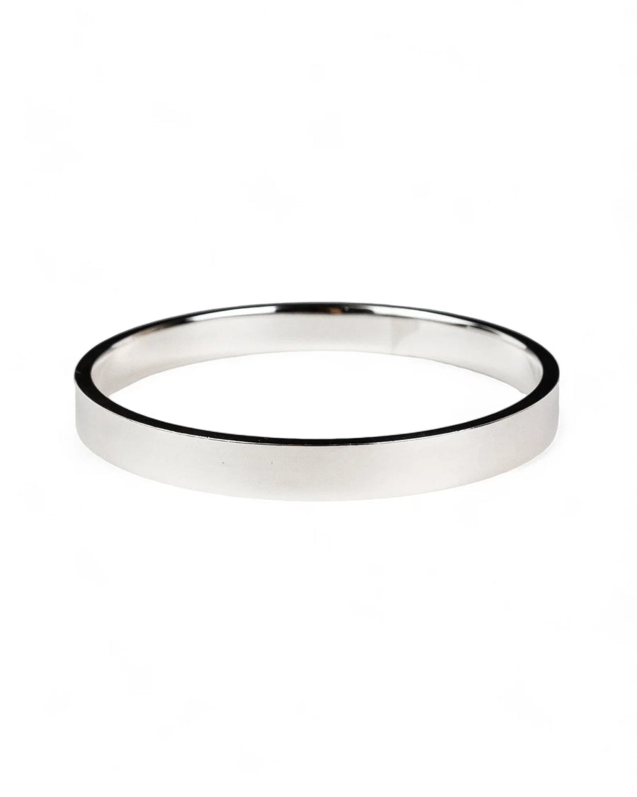 Handmade rectangular solid silver bangle with smooth 8mm wide band on white background