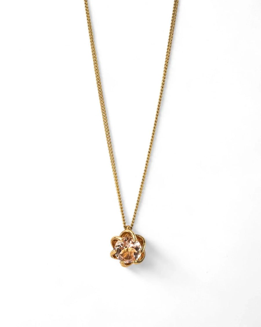 Yellow gold pendant necklace with claw-set morganite gemstone on a white background