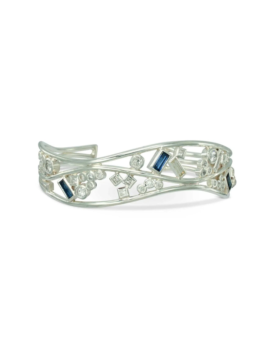 Handmade silver cuff bangle with blue sapphires and diamond baguettes in an organic design