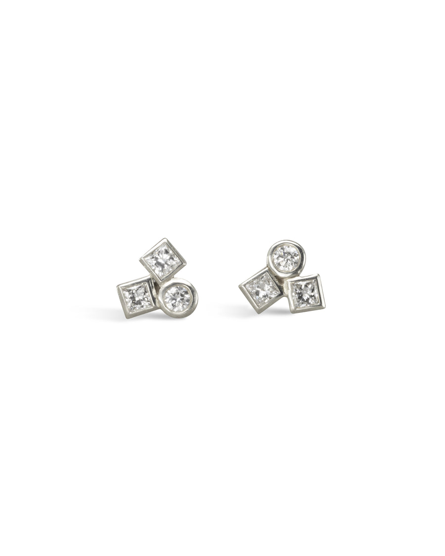 Silver stud earrings with round and square diamonds.