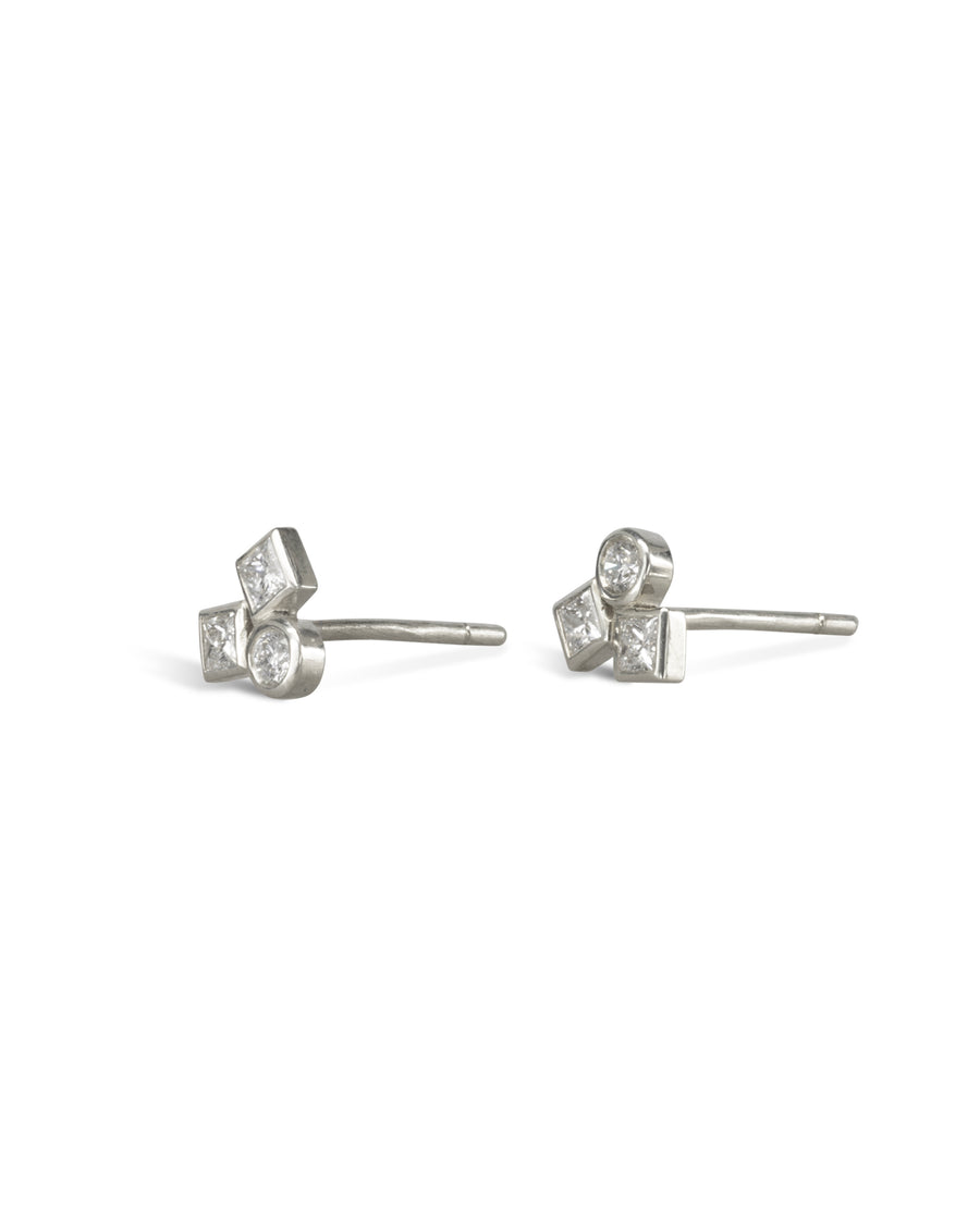 Gold stud earrings with three round and square diamonds.