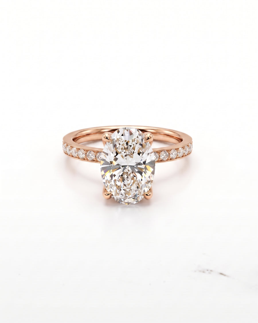 A rose gold engagement ring featuring a large oval-cut center stone and a pavé-set diamond band, photographed on a clean white background.