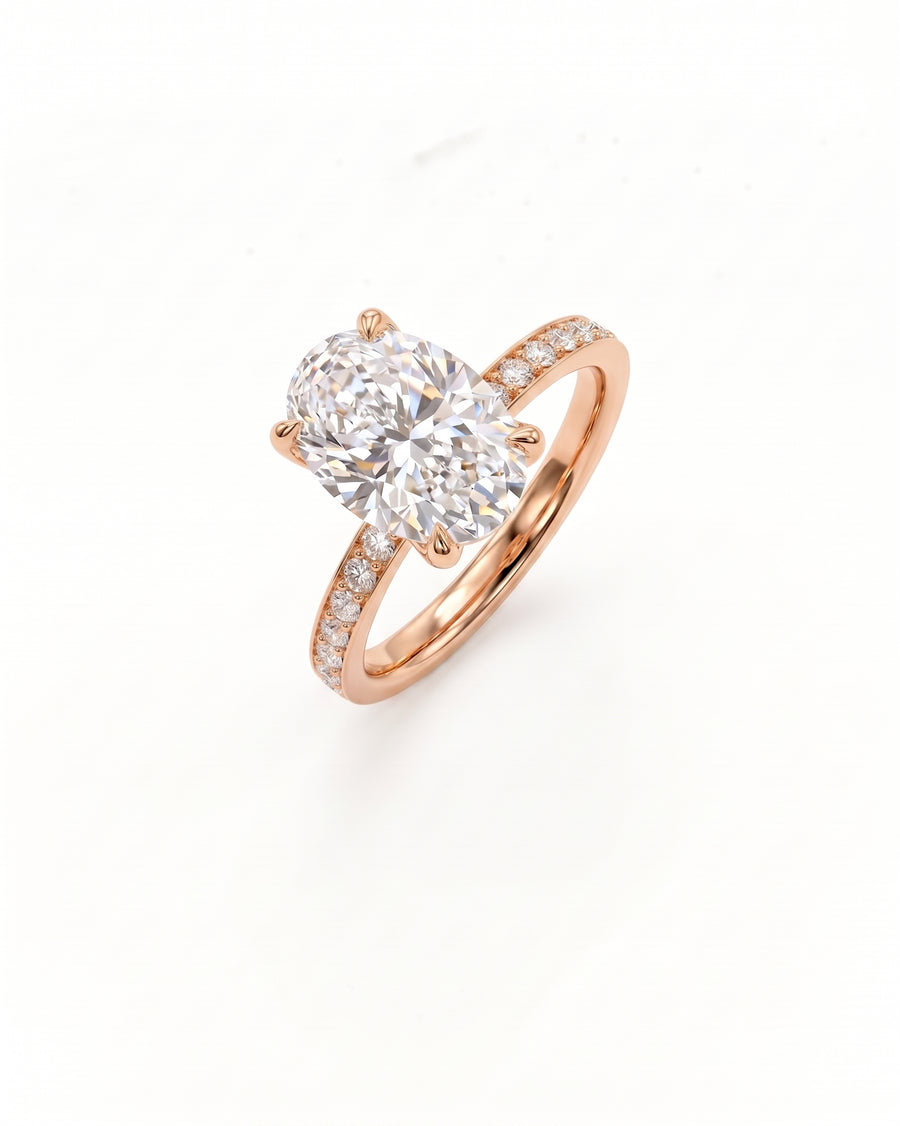 A rose gold engagement ring featuring a large oval-cut center diamond and a pavé-set diamond band, shown on a clean white background.