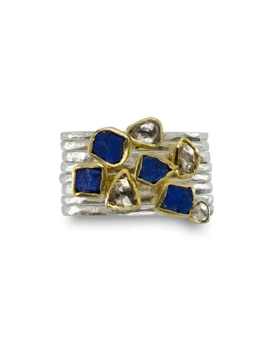 Stacked silver rings with rough-cut lapis lazuli and diamond gemstones in gold bezels