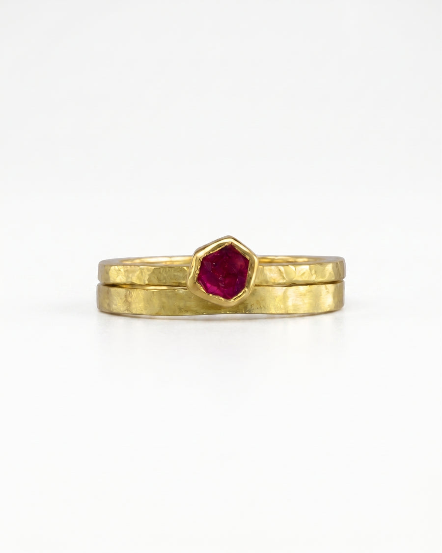 Rough cut ruby yellow gold ring set with a hexagonal ruby.