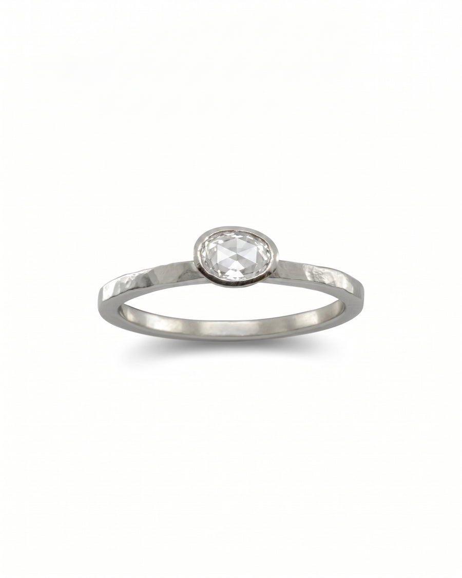 Silver ring with an oval rough diamond.