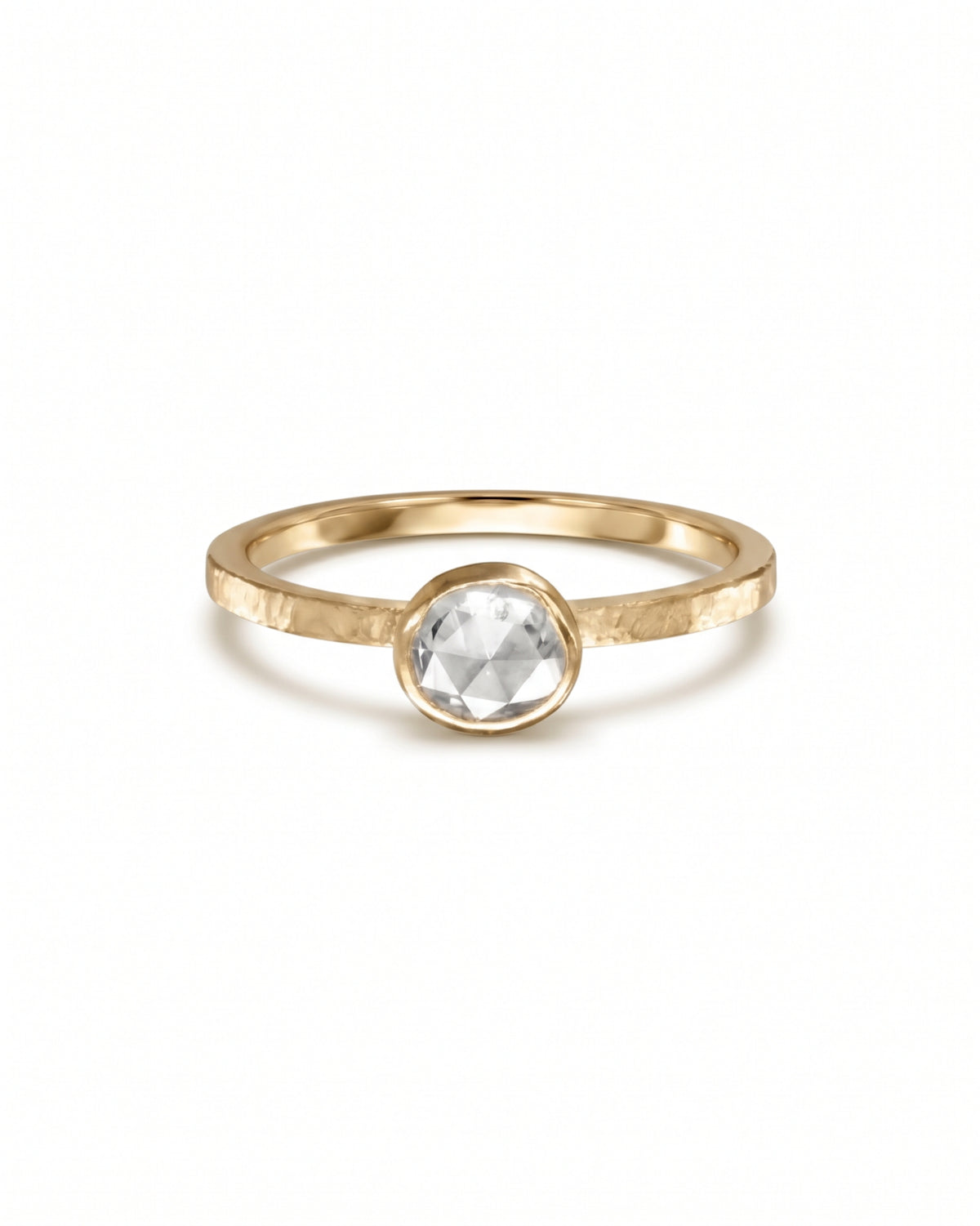 Bezel-set rose cut diamond ring on a hammered yellow gold band.