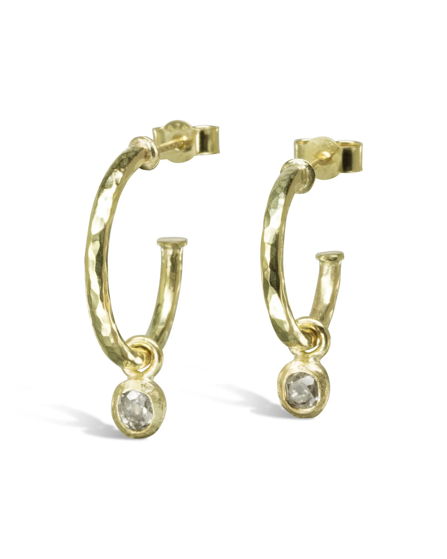 Gold hammered hoop earrings with rough diamond drops.