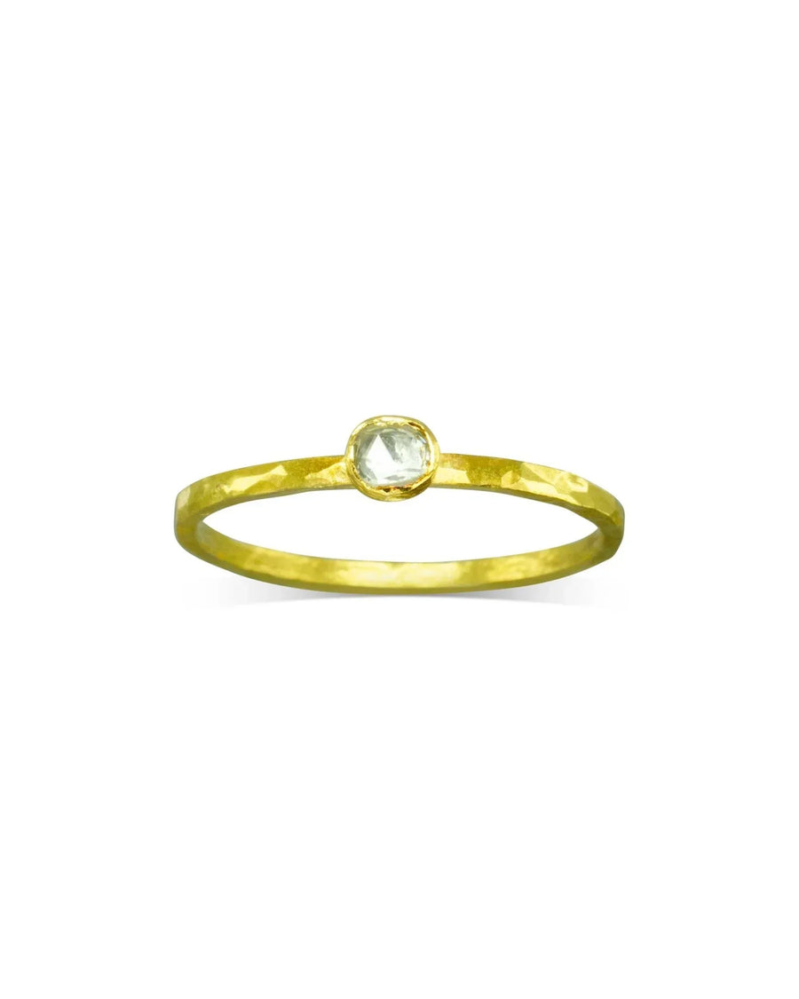 Gold stacking ring with a rough diamond in a bezel setting.