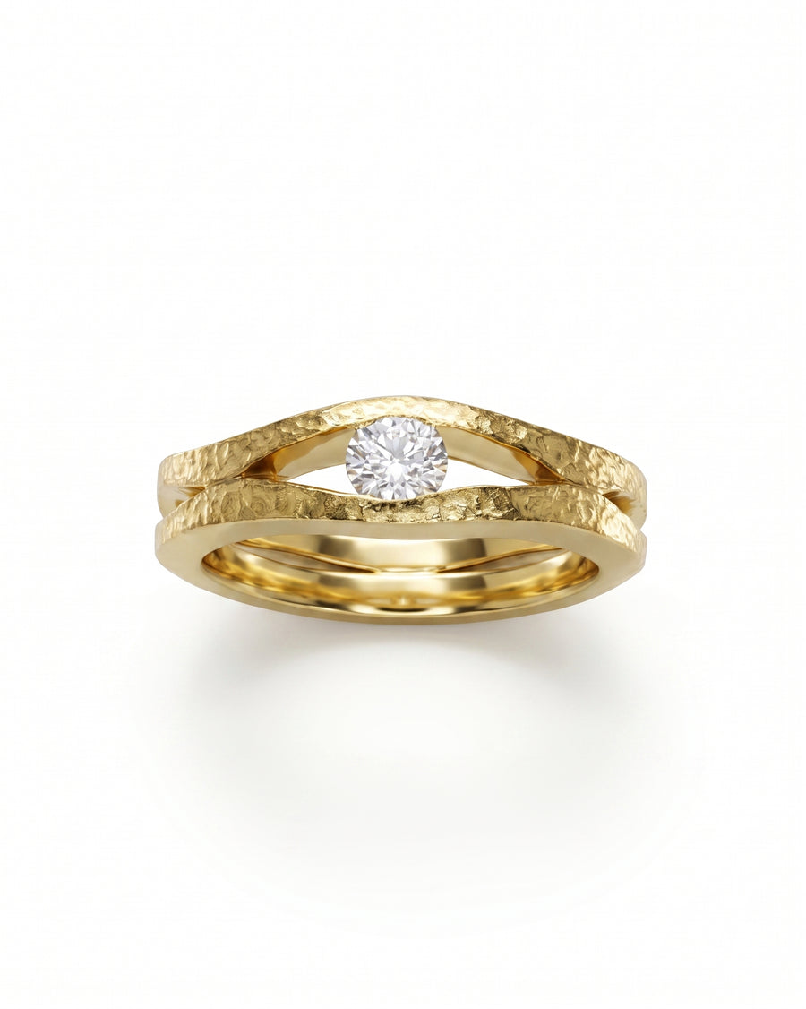Rough hammered gold diamond trap solitaire engagement ring.