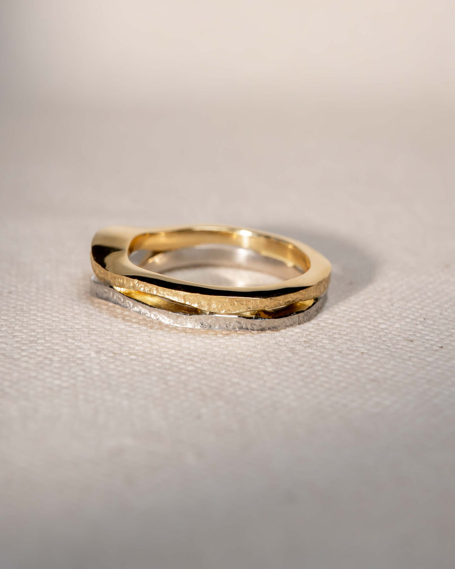 Rough hammered gold and silver diamond trap solitaire engagement ring.