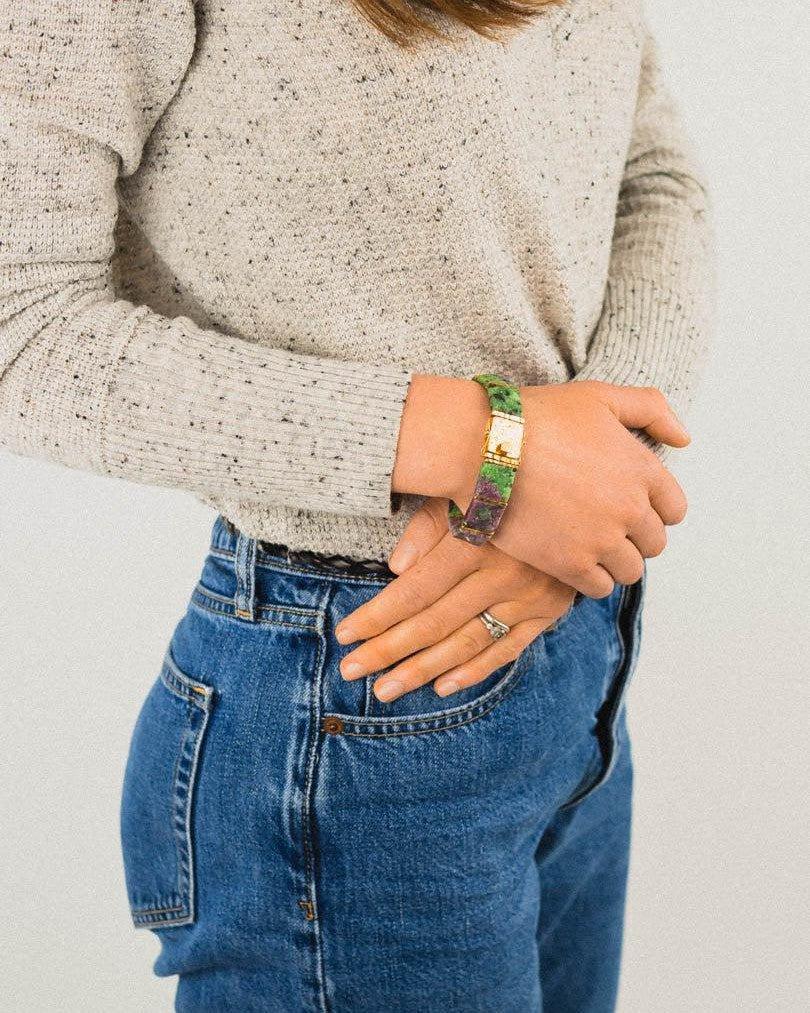 Woman wearing a chunky rough ruby zoisite gemstone bracelet with gold accent